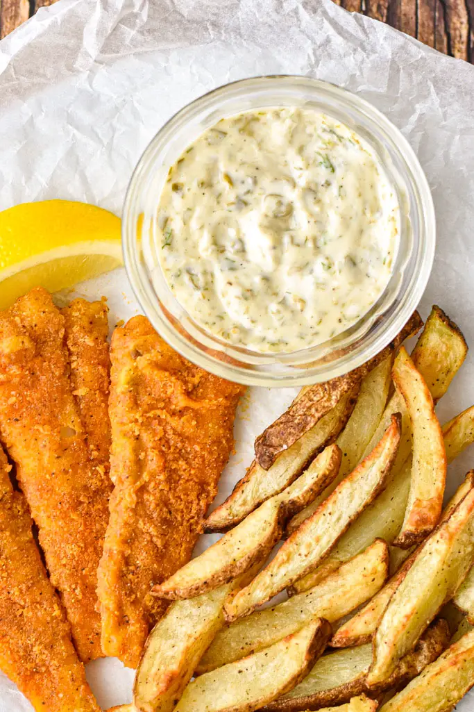 tartar sauce on a plate with fish and chips and a slice of lemon